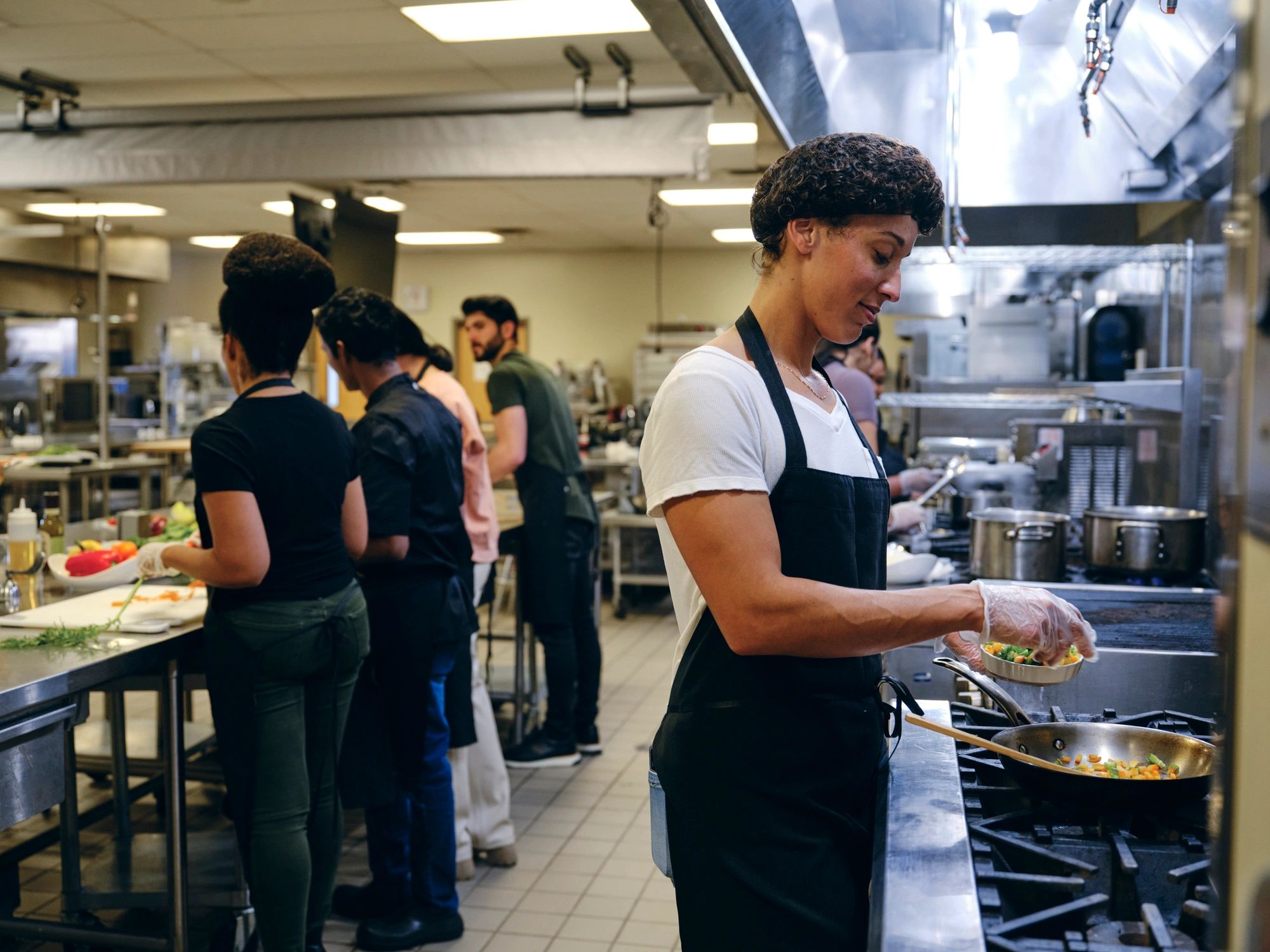 Cook working in a commercial kitchen, representing made-from-scratch preparation
